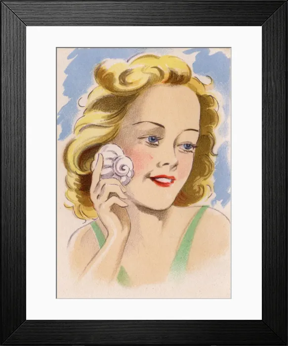 Framed Print : Pretty French girl putting a shell to her ear Framed Print : Pretty French girl putting a shell to her ear