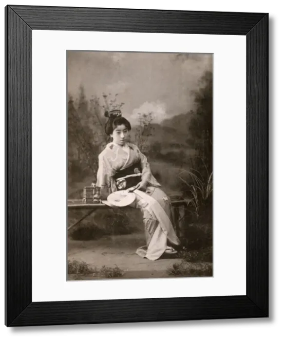 Framed Print : A Japanese Geisha posing in a studio garden setting Framed Print : A Japanese Geisha posing in a studio garden setting