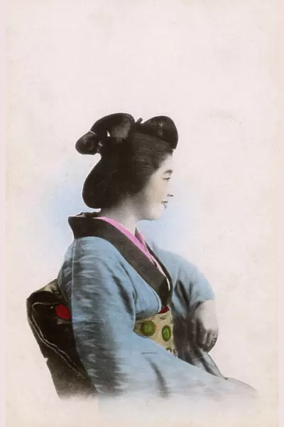Profile portrait of a smiling Japanese Geisha girl