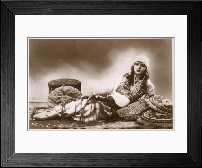 Framed Print : Pretty Hungarian Girl reclining amongst cushions