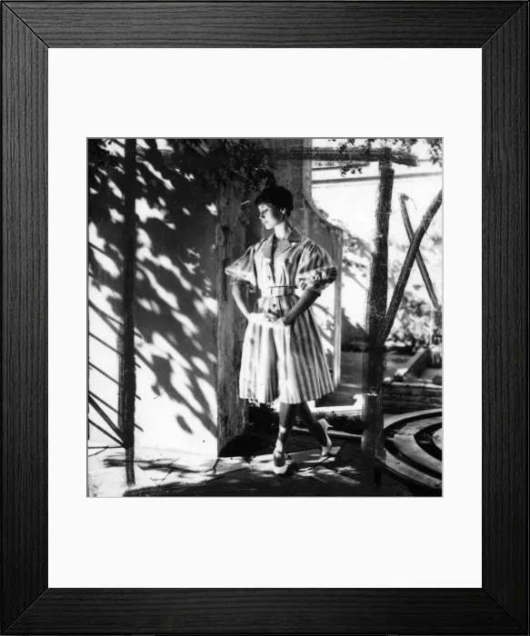 Framed Print : Young woman modelling a dress in a garden Framed Print : Young woman modelling a dress in a garden
