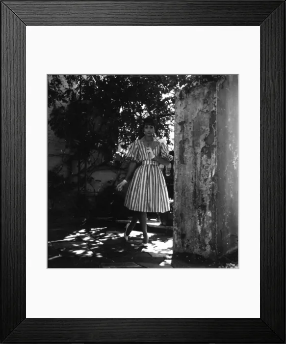 Framed Print : Young woman modelling a dress in a garden Framed Print : Young woman modelling a dress in a garden