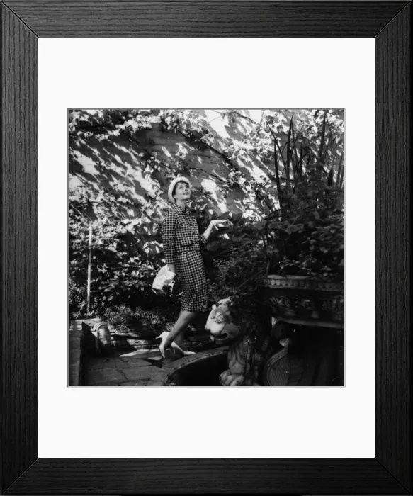 Framed Print : Young woman modelling a suit in a garden Framed Print : Young woman modelling a suit in a garden