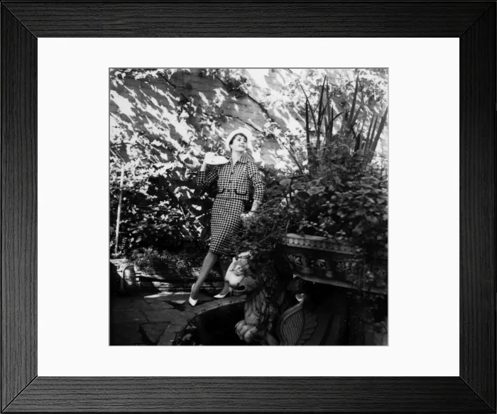 Framed Print : Young woman modelling a suit in a garden Framed Print : Young woman modelling a suit in a garden