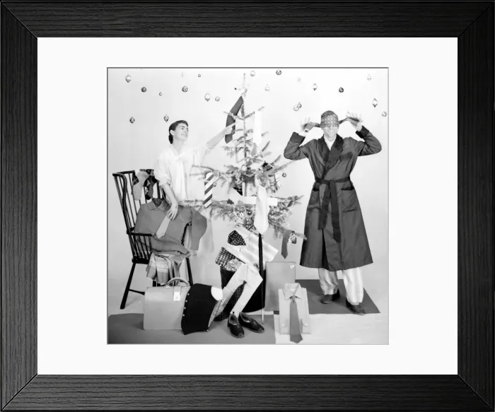 Framed Print : Male and female models in Christmas morning scene Framed Print : Male and female models in Christmas morning scene