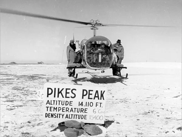 Bell Model 47G-3 hovers atop Pikes Peak with pilot and f?