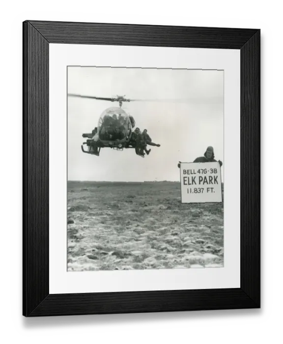 Framed Print : Bell Model 47G-3B hovers at Elk Park with eight men aboard Framed Print : Bell Model 47G-3B hovers at Elk Park with eight men aboard