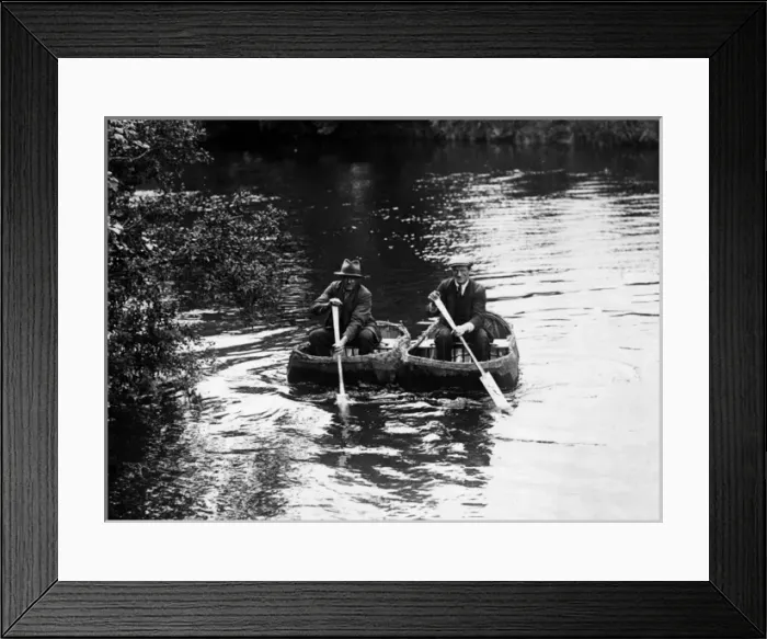 Framed Print : CORACLES. Two old men, paddling along a river in coracles. Date: 1930s Framed Print : CORACLES. Two old men, paddling along a river in coracles. Date: 1930s