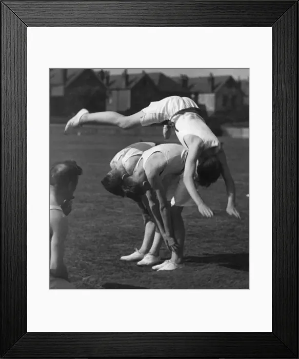Framed Print : LEAPFROG. A boy doing an impressive leapfrog over two other boys! Date: 1930s Framed Print : LEAPFROG. A boy doing an impressive leapfrog over two other boys! Date: 1930s