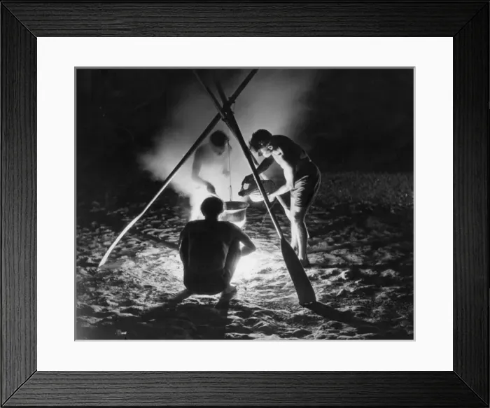 Framed Print : CAMP FIRE. Three young men cooking a meal on a beach Framed Print : CAMP FIRE. Three young men cooking a meal on a beach