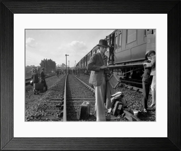 Framed Print : People on a railway track alongside a train Framed Print : People on a railway track alongside a train