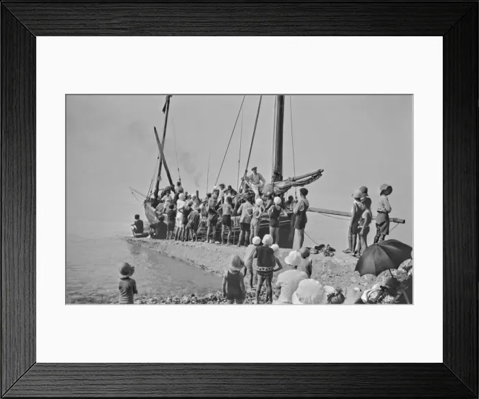 Framed Print : People on and around a boat by a jetty - France Framed Print : People on and around a boat by a jetty - France