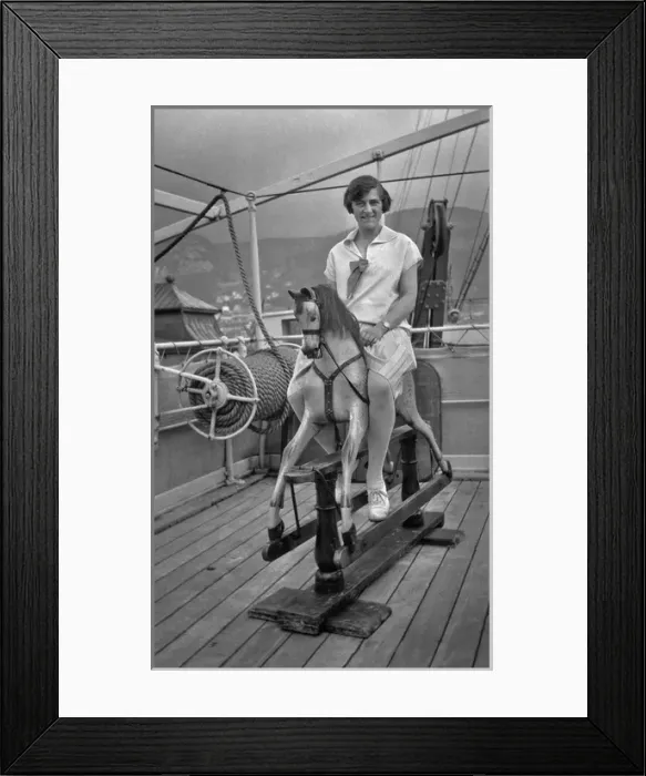 Framed Print : Woman riding a hobby horse on board ship Framed Print : Woman riding a hobby horse on board ship