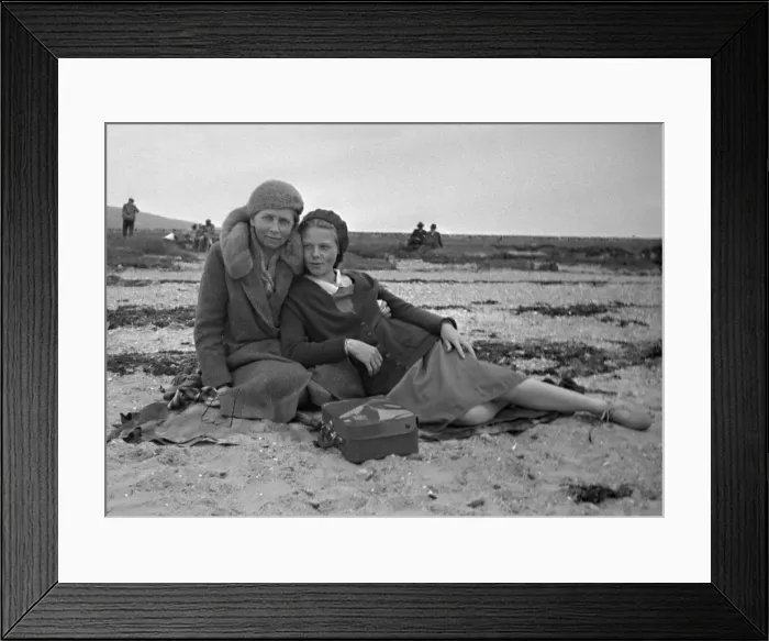 Framed Print : Mother and daughter sitting on a beach Framed Print : Mother and daughter sitting on a beach