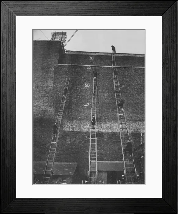 Framed Print : Firefighters climbing wheeled escape ladders Framed Print : Firefighters climbing wheeled escape ladders