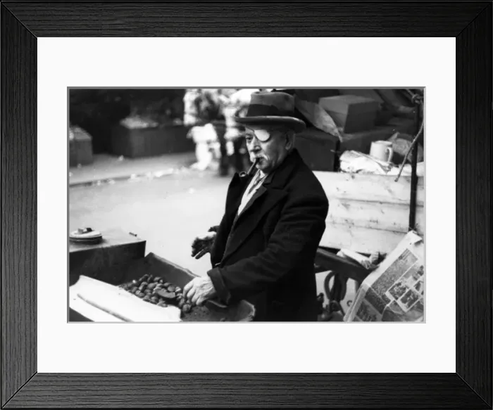 Framed Print : One-eyed man roasting chestnuts at market Framed Print : One-eyed man roasting chestnuts at market