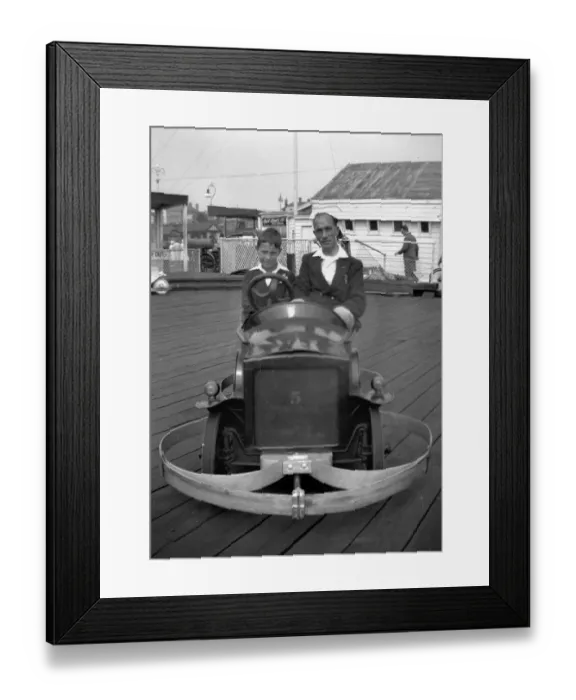 Framed Print : Man and boy in dodgem car Framed Print : Man and boy in dodgem car