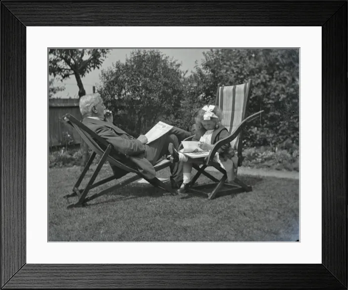 Framed Print : Elderly man and little girl in a garden Framed Print : Elderly man and little girl in a garden