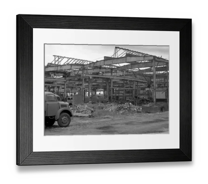 Framed Print : Shell of a building with parked vehicles Framed Print : Shell of a building with parked vehicles