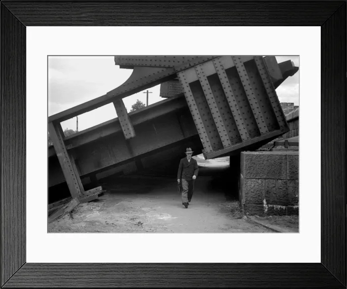 Framed Print : Man walking under collapsed structure, WW2 Framed Print : Man walking under collapsed structure, WW2