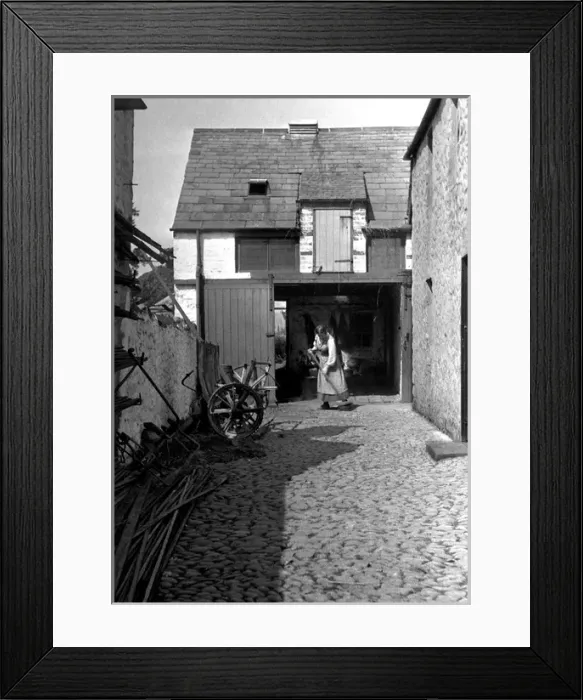 Framed Print : Woman sweeping a yard Framed Print : Woman sweeping a yard