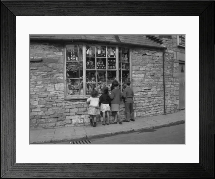Framed Print : Four children gazing through shop window Framed Print : Four children gazing through shop window