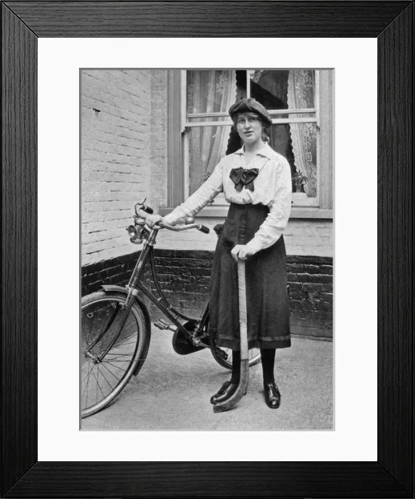 Framed Print : Young woman with bicycle and hockey stick Framed Print : Young woman with bicycle and hockey stick