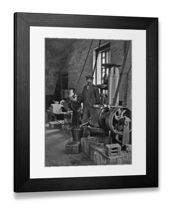 Framed Print : Workman in a factory operating machinery - lead works Framed Print : Workman in a factory operating machinery - lead works