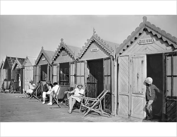 People outside beach huts, Cayeux, France