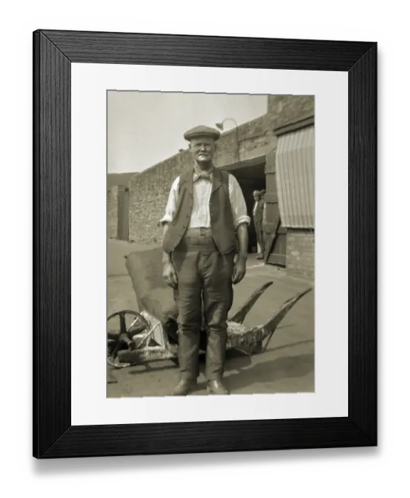 Framed Print : Workman standing in a yard Framed Print : Workman standing in a yard