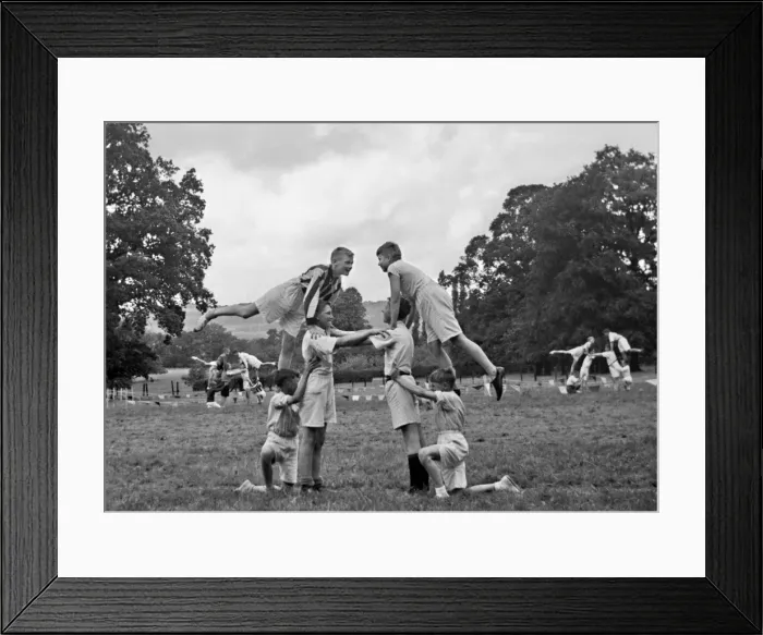 Framed Print : Boys doing acrobatics in a field Framed Print : Boys doing acrobatics in a field