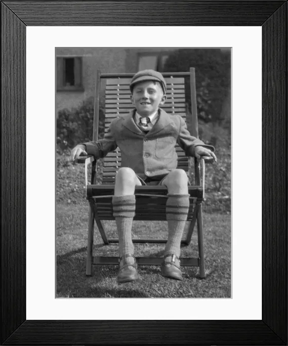 Framed Print : Schoolboy sitting in a garden chair Framed Print : Schoolboy sitting in a garden chair