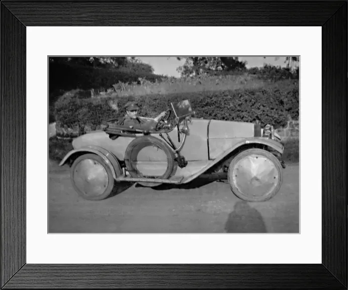Framed Print : Man in uniform driving sports car Framed Print : Man in uniform driving sports car