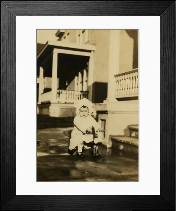 Framed Print : Young girl on a wooden trike Framed Print : Young girl on a wooden trike