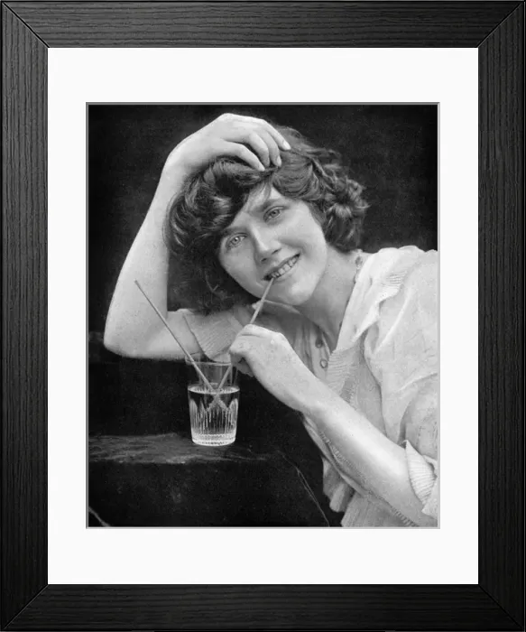 Framed Print : Portrait of a girl drinking water through a straw Framed Print : Portrait of a girl drinking water through a straw