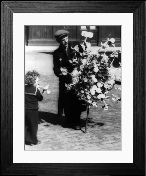 Framed Print : Man selling toy windmills Framed Print : Man selling toy windmills