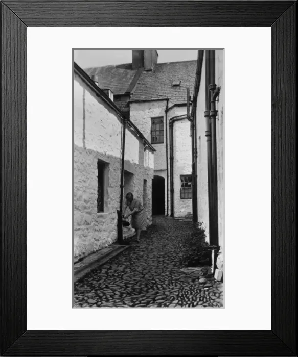 Framed Print : Woman filling kettle from outdoor tap, Newhaven, Sussex Framed Print : Woman filling kettle from outdoor tap, Newhaven, Sussex