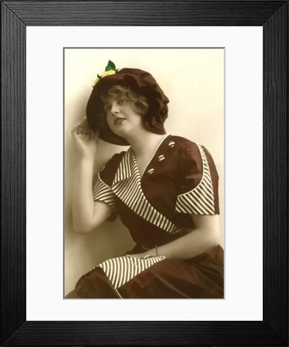 Framed Print : Woman wearing a hat and stripey dress Framed Print : Woman wearing a hat and stripey dress