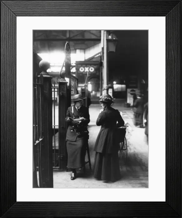 Framed Print : A female ticket collector at platform five in a London train Framed Print : A female ticket collector at platform five in a London train