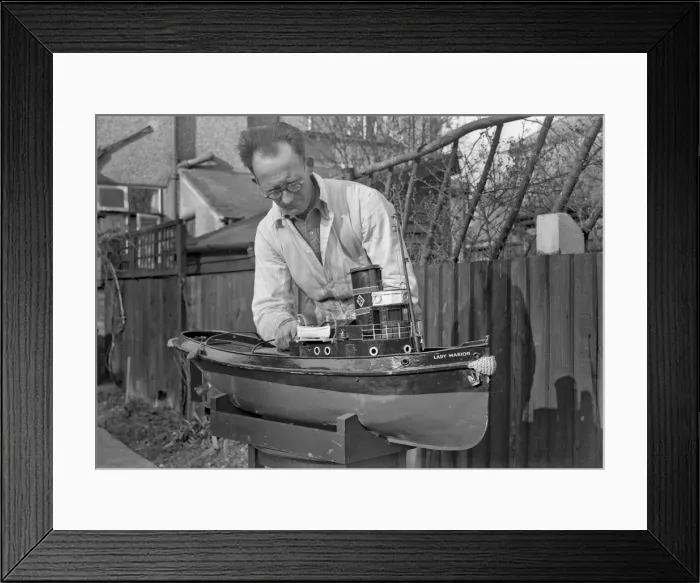 Framed Print : Man making model boat in garden Framed Print : Man making model boat in garden