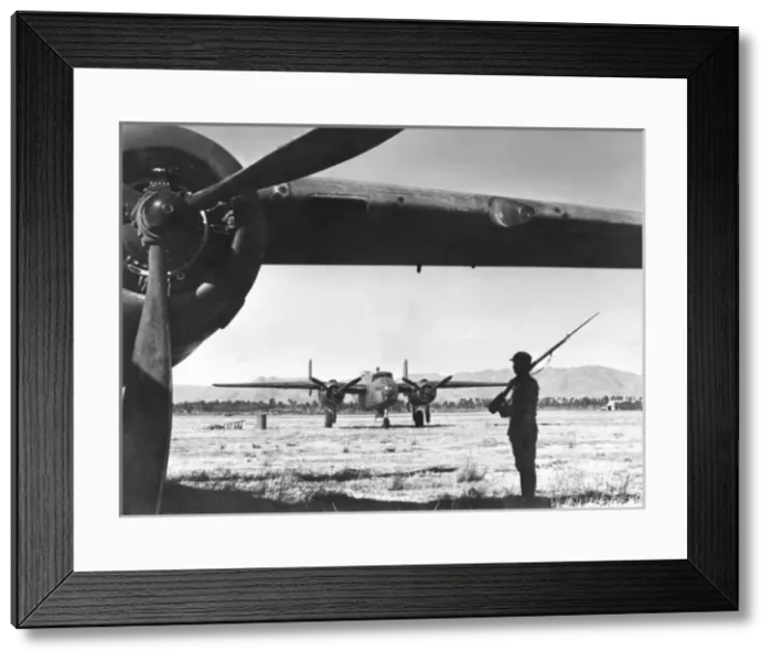 Framed Print : Chinese sentry guards American bomber Framed Print : Chinese sentry guards American bomber