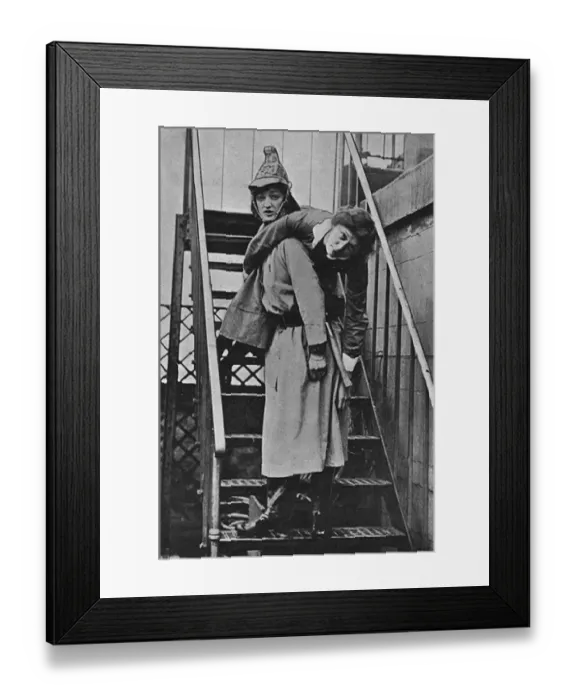 Framed Print : Firewomen, a rescue on an iron staircase, WW1 Framed Print : Firewomen, a rescue on an iron staircase, WW1