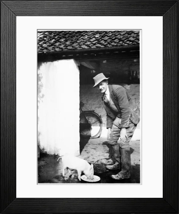 Framed Print : Farmer and piglet Framed Print : Farmer and piglet