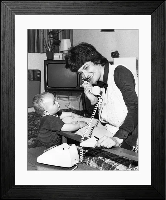 Framed Print : Woman on the phone, with toddler Framed Print : Woman on the phone, with toddler