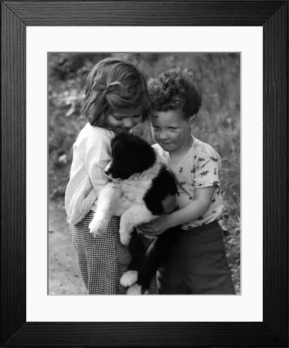 Framed Print : Girl and boy with puppy Framed Print : Girl and boy with puppy
