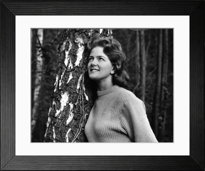 Framed Print : Young woman leaning against a tree Framed Print : Young woman leaning against a tree