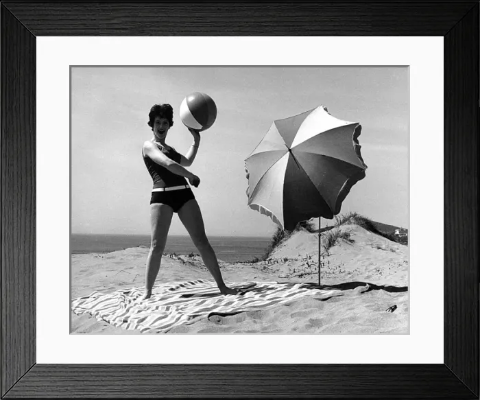 Framed Print : Woman on beach with ball and sunshade Framed Print : Woman on beach with ball and sunshade
