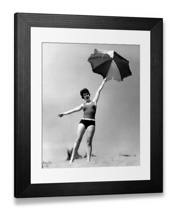 Framed Print : Woman on beach with sunshade Framed Print : Woman on beach with sunshade