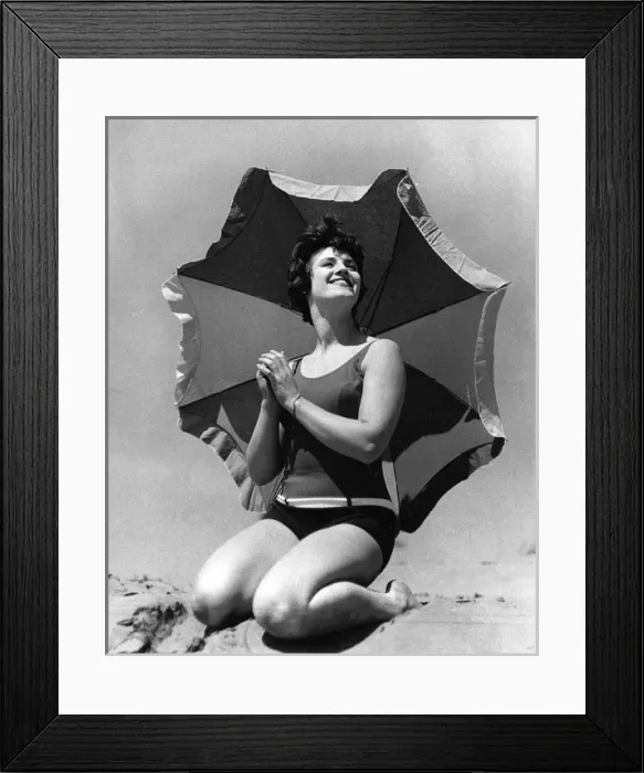 Framed Print : Woman on beach with sunshade Framed Print : Woman on beach with sunshade