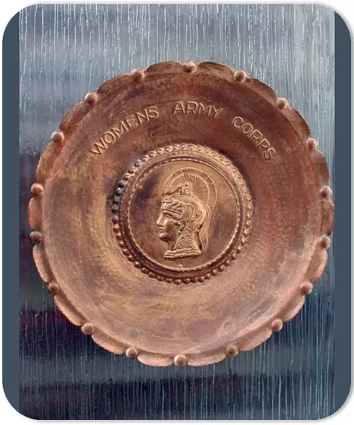 A handmade metal plate, stamped Womens Army Corps